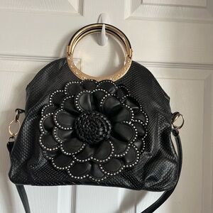 Black pocketbook with large embossed flower trim silver front,zipper pocket back